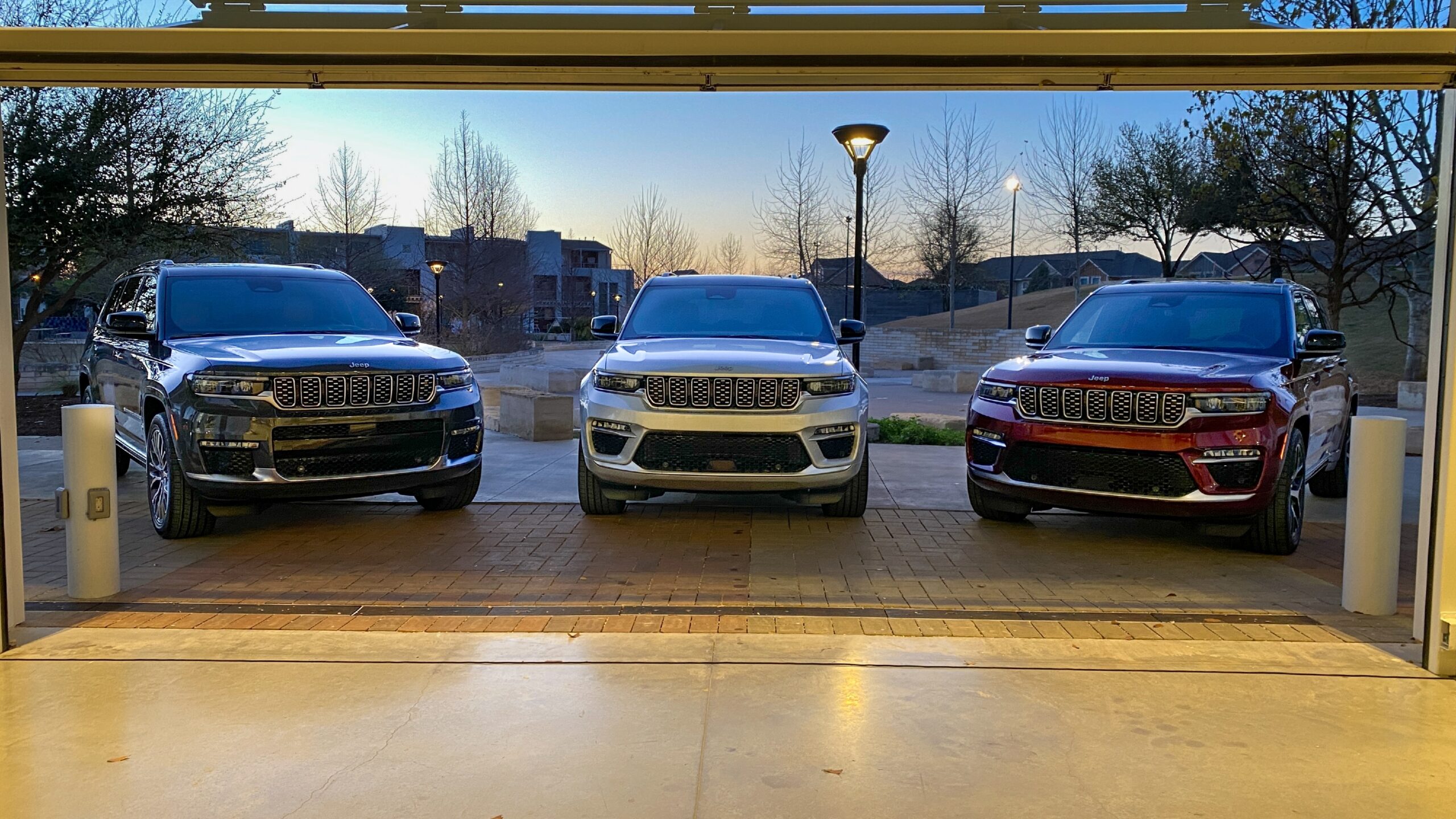 Three Jeep Grand Cherokee SUVs parked outdoors in Fresno, CA.